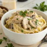 Creamy chicken mushroom pasta in white bowl